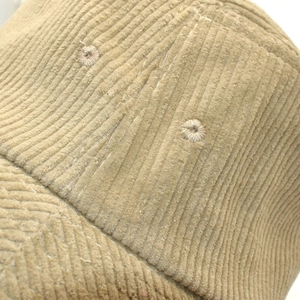 Close-up of khaki corduroy fabric texture and fine stitching on a winter bucket hat