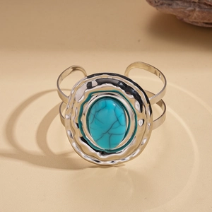 Detail of silver bohemian cuff bracelet with large oval turquoise stone inlay