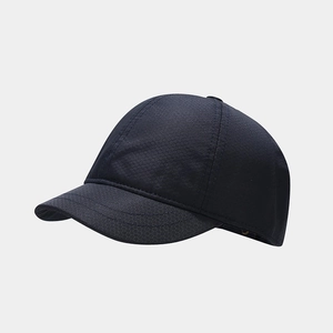 Detailed close-up of dark blue short brim baseball cap with honeycomb textured fabric