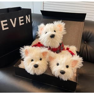 Detailed close-up of a plush West Highland terrier doll in a premium black gift box
