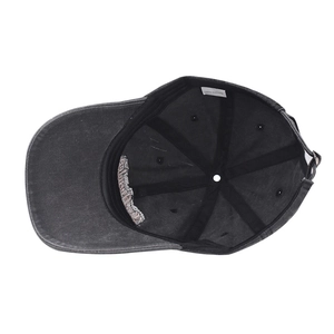 Detail view of cotton baseball cap interior showing black sweatband and 100% cotton label