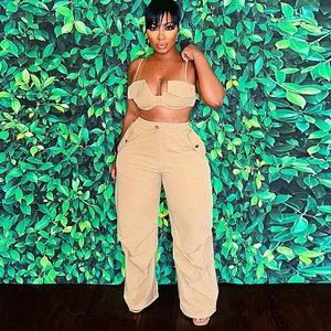 Detail of khaki cargo style crop top and drawstring wide leg trousers on a model