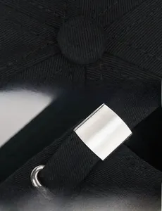 Detail of adjustable metal buckle and stitching on black distressed baseball cap