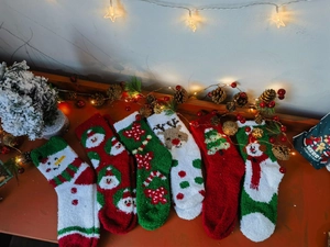 Cozy Christmas coral fleece socks set featuring reindeer and santa on wood background