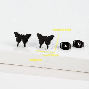 Macro detail of matte black butterfly stud earrings with dimensions 1cm x 0.8cm and 2g weight