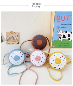 Close-up of cute donut-shaped mini crossbody bags in blue, pink, yellow, and brown faux leather