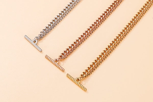 Detail of double-layer chain necklaces in silver, rose gold and gold with OT toggles
