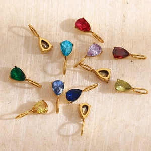 Macro shot of colorful teardrop birthstone pendants with 18K gold plated settings