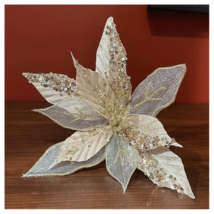 Detail showing champagne glitter mesh Christmas flower on a wooden surface backdrop