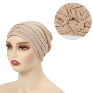 Beige high-elasticity turban hat for women featuring a pleated back detail on white background