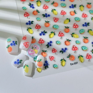 Detailed macro view of 5D embossed nail stickers featuring colorful 3D fruit patterns