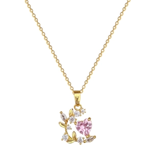 Elegant gold necklace with pink heart-shaped crystal and leaf pendant with clear zircons