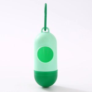 Green capsule-shaped dog waste bag dispenser with portable hook on white background