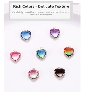 Detailed close-up of gold-plated heart charms with gradient crystal and faceted edges