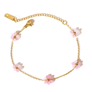 Gold stainless steel bracelet featuring five delicate pink and white gradient floral charms