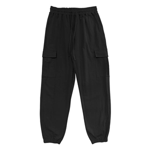 Flat lay of black cargo pants featuring elastic drawstring waist and large utility side pockets