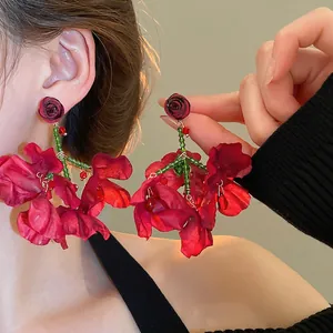 Artistic oversized red fabric rose tassel earrings with green beaded stem for women
