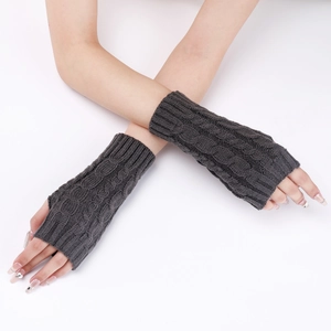 Close-up of dark grey cable knit fingerless gloves showing detailed wool texture