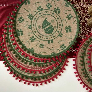 Christmas jute placemats with festive prints and decorative colorful pom-pom fringe