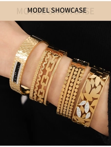 Detail of four gold hollow bracelets with honeycombs and diamonds on model wrist