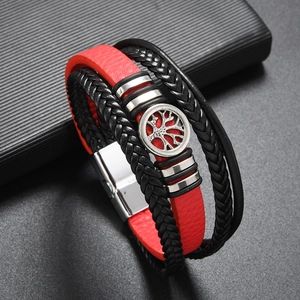 Detail of red and black multi-layer woven leather bracelet with silver Tree of Life charm