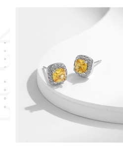 Detail of S925 silver stud earrings featuring yellow square zircon with halo diamonds