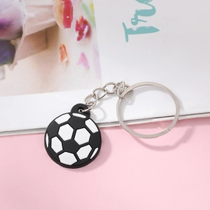 Close-up of a classic black and white PVC soccer ball keychain with a metal chain ring