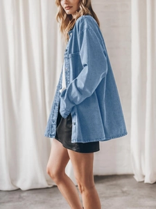 Detailed side view of loose-fit blue denim shirt jacket with large pockets and lapel collar