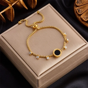 Gold titanium steel bracelet with black Roman numeral pendant and zircon accents