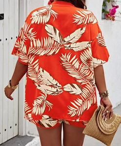 Rear view of orange tropical leaf print two-piece shirt and shorts set for summer
