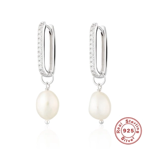 Detailed close-up of 925 sterling silver earrings with baroque pearls and zircon stones