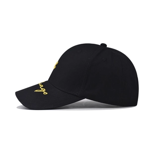 Close-up of yellow Chicago embroidery on the side of a black washed cotton baseball cap