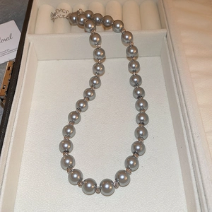 Vintage grey pearl choker necklace with silver metal spacers in a jewelry box