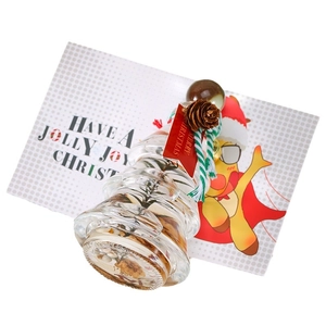 Christmas tree shaped glass aromatherapy bottle with cork, pine cone, and festive tag