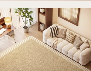 Detail of a beige woven rug with striped borders in a cozy French retro living room