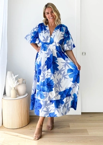 Detail of V-neckline and puff sleeves on floral print A-line maxi dress in blue and white