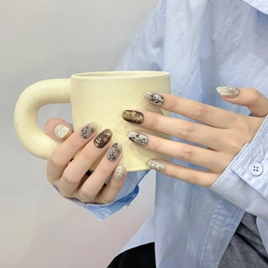 Hand-painted bamboo style press-on nails with brown and silver glitter leaf patterns