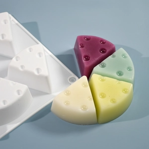 Detailed view of 8-cavity triangle cheese silicone mold with colorful resin cake samples