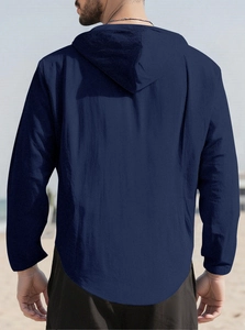 Back view of a dark blue men's casual hooded shirt on a beach setting showing fabric texture
