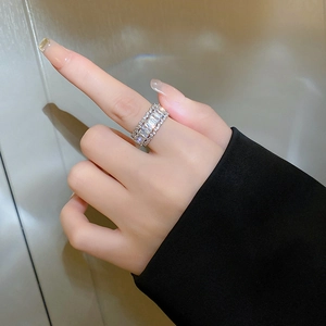 Detailed close-up of a silver zircon open ring with rectangular cut crystals on hand