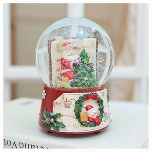 Macro detail of Christmas snow globe with Santa Claus inside and festive resin base
