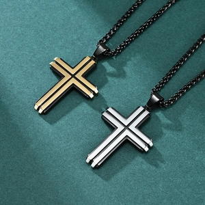 Two-tone stainless steel cross necklaces in gold-black and silver-black on green texture