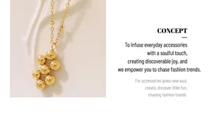 Macro detail of gold-plated geometric cluster pendant necklace on a delicate link chain
