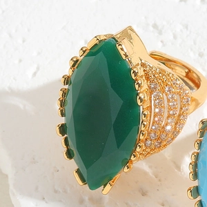 Macro shot of marquise-cut green emerald zircon ring with gold-plated vintage finish
