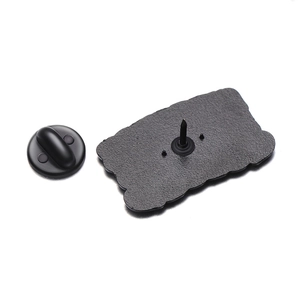 Detailed back view of a black metal enamel pin with a secure rubber clutch backing