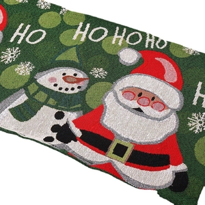 Knitted Christmas table runner with Santa, snowman, and snowflake patterns on green fabric