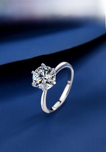 Detailed view of 2ct D color moissanite ring with classic six-prong setting on silk