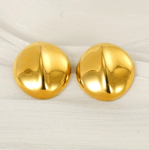 Detail view of 18K gold plated stainless steel heart earrings on white silk fabric