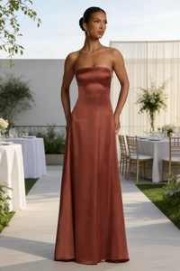 Detail of elegant backless satin evening gown in bronze with waist cinching silhouette