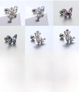 Detail view of butterfly and flower earrings with pink and blue zircons in steel